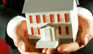 Man holding model home