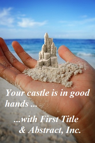 Hand holding a sand castle